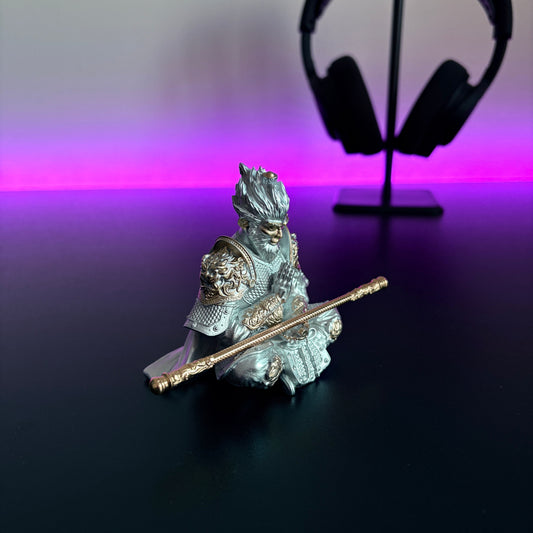 Decorative figurine of a warrior with a spear on a reflective surface with a blurred background